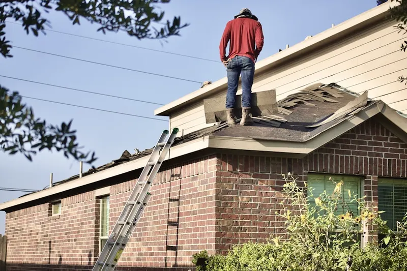 Professional roofer working on a residential roof in Royal Center